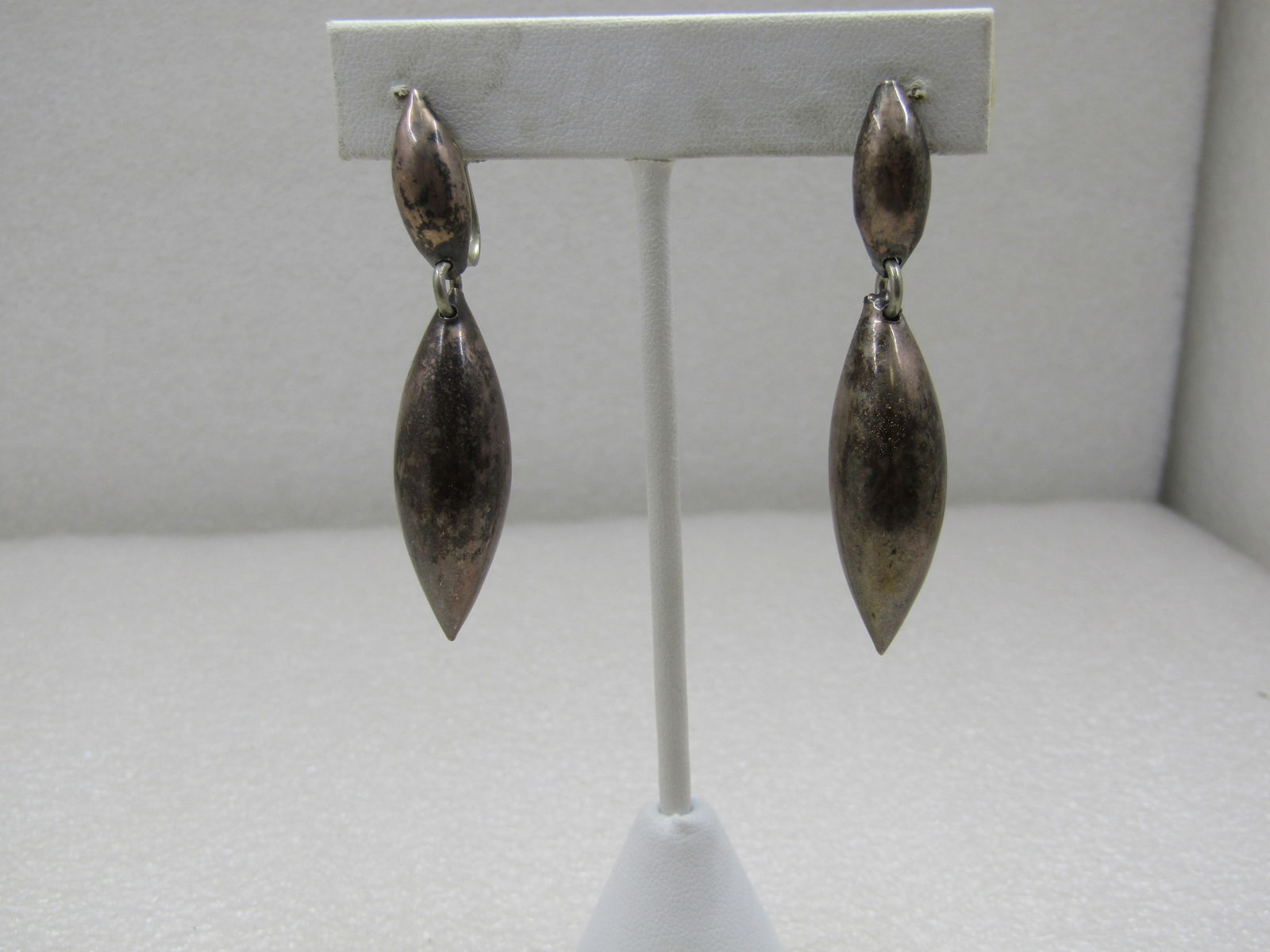 Vintage Sterling Mexican Drop Earrings, Screwback - Mid-Century, Signed: Vintage Sterling Mexican Drop Earrings, Screwback - Mid-Century. They have a domed cateye shaped stud from which a puffy drop dangles, an elongated pointed bead. The total length of the earrings is 2.