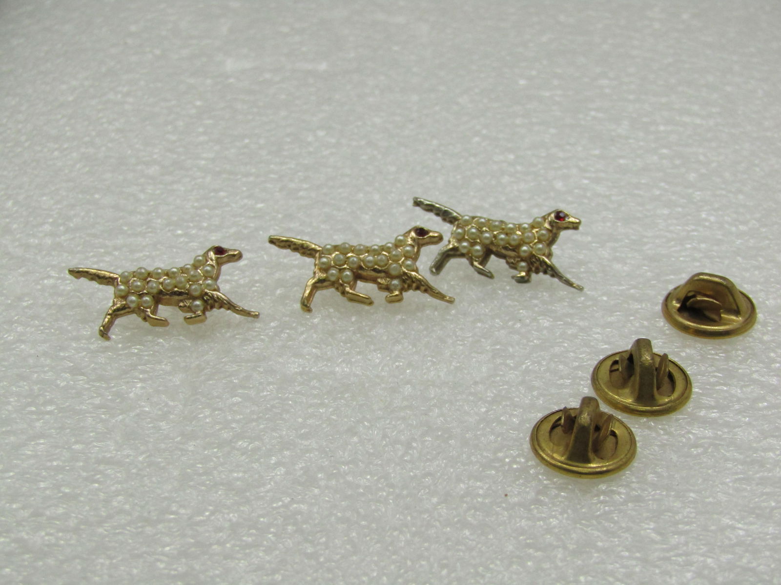 Vintage Faux Pearl Spaniel Dog Scatter Pins, 1950's-1960's: Vintage Faux Pearl Spaniel Dog Scatter Pins, 1950's-1960's. Three matching faux pearl spaniels with red rhinestone eyes. They are appx. 1" tall wide and 1/2" tall. Great as tack pins or scatter pins.