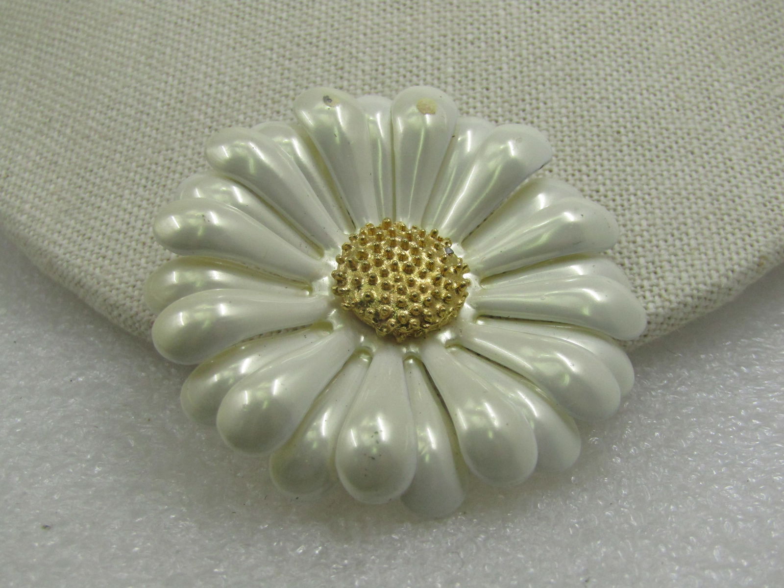 Vintage Pearly White Enameled Blossom Brooch, Gold Center, 1960's: Vintage Pearly White Enameled Blossom Brooch, Gold Center, 1960's. Appx. 2-1/8" wide. Recessed in the center with a textured gold tone center and curved and rounded two layers of pearly white petals.