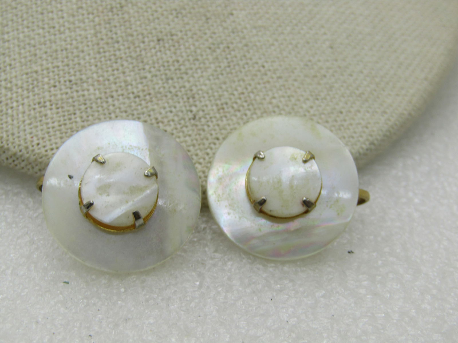 Mid-Century Mother-of-Pearl Earrings, Tiered, Clip: Mid-Century Mother-of-Pearl Earrings, Tiered, Clip, 1" round with a hat-like shape in that there is a center 1/2" MOP disc, prong-set that sits higher than the 1" frame. 1950's-1960's. Not signed by t