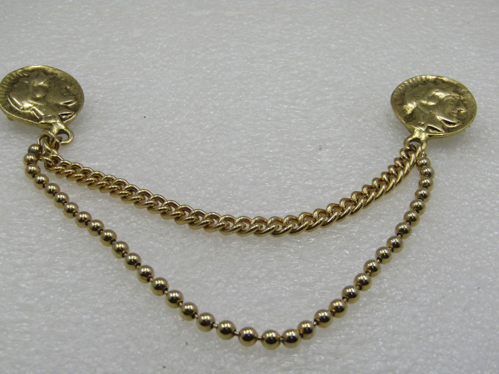 Vintage Roman Coin & Chain Draping Brooch, 1960's: Vintage Roman Coin & Chain Draping Brooch Set, 1960's. 7.5" wide from coin to coin with a draping double chain length between, one is a 5.5mm wide curb link chain that is 5" long and the longer chain