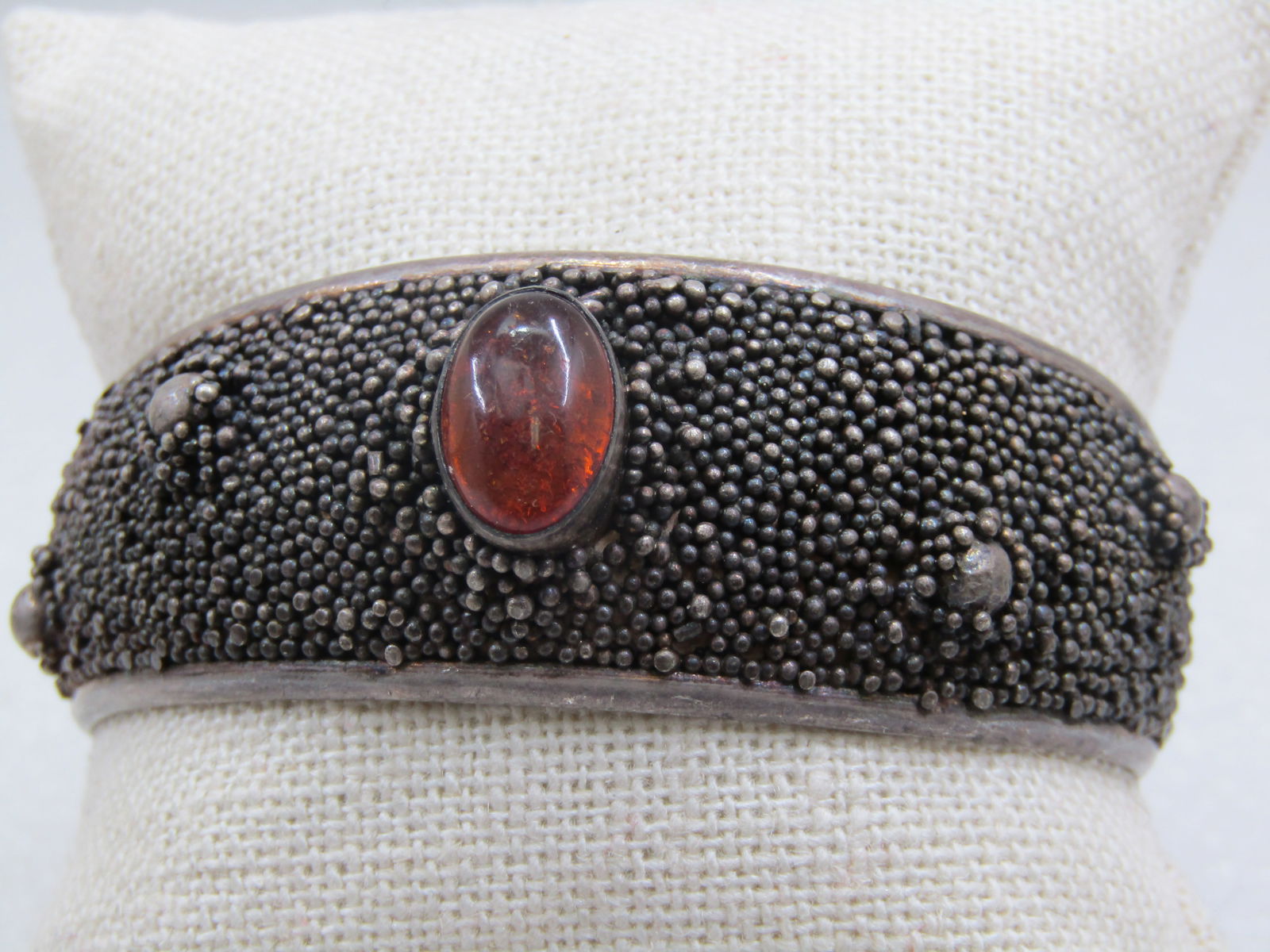 Vintage Sterling Amber Modernist Heavy Microbeaded Cuff Bracelet, 6.75": Vintage Sterling Amber Heavy Micro beaded Cuff Bracelet, 6.75". Modernist to brutalist design. Marked .925 and tested. Weight is appx. 30.19 gr. Bezel-set 13mm by 8mm oval amber cabochon set in the ce