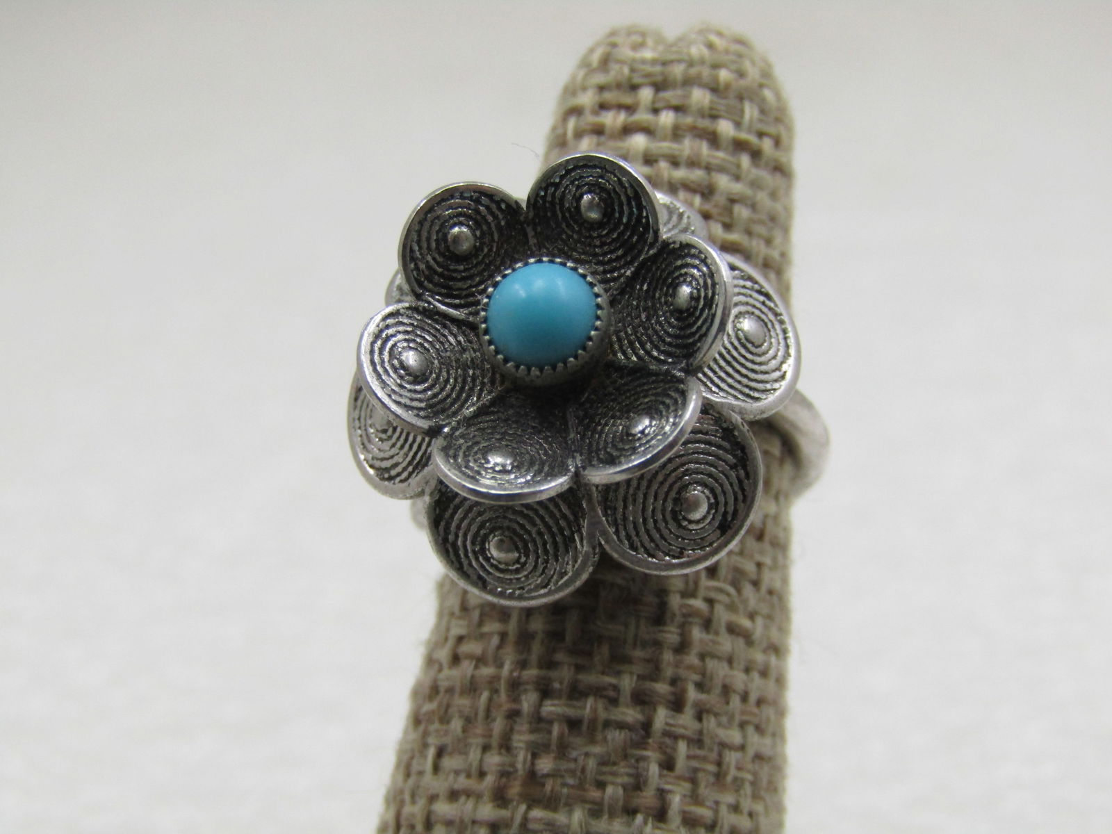 Vintage Faux Turquoise Tiered Blossom Ring, Adjustable: Vintage Faux Turquoise Tiered Blossom Ring, Adjustable sz. 5-9. Signed Sarah Coventry. Each of the six petals on top and bottom look like a coiled wrap, the bottom tier tuns downward and the upper