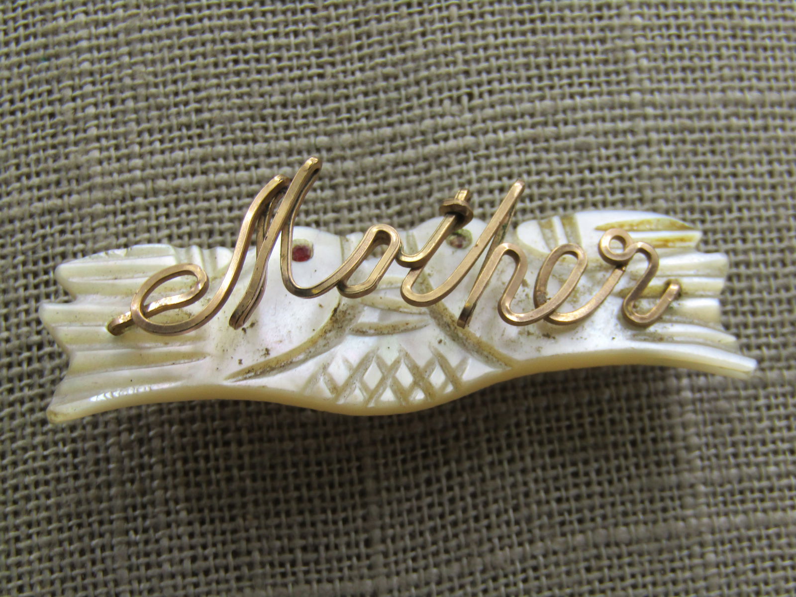 Vintage Mother-of-Pearl Doves Mother Brooch. Hand-Made: Vintage Mother-of-Pearl Doves Mother Brooch. Hand-Made, 2" by 5/8" made with 10kt G.F square wire. The doves have carved details and each has a red enameled eye - they gace eachother. Age is