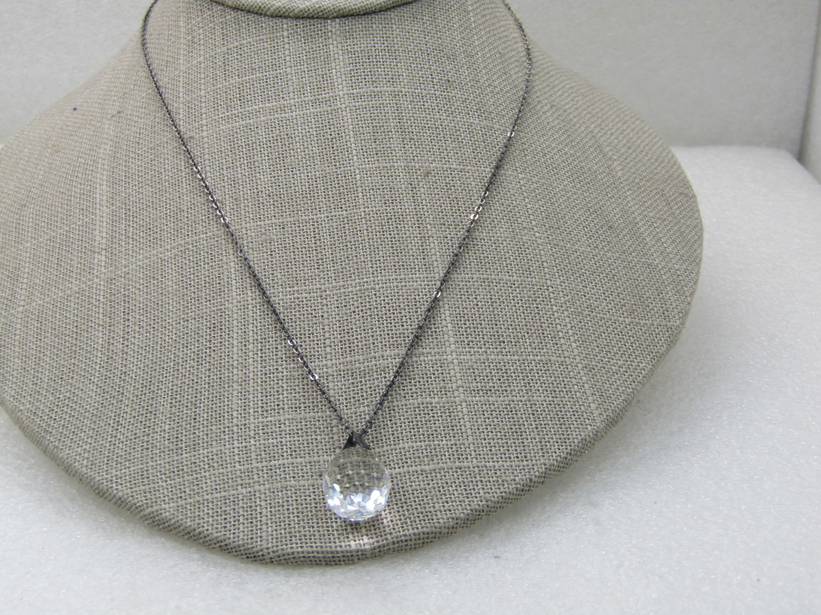 Vintage Faceted Crystal Drop Necklace, 18", 3/4" Drop Pendant: Vintage Faceted Crystal Drop Necklace, 18", 3/4" Drop Pendant, 1/2" wide teardrop shaped with a silver tone bail. Chain is silver tone. Appx 1mm wide. Spring Clasp. Not signed. Some oxidation on the c