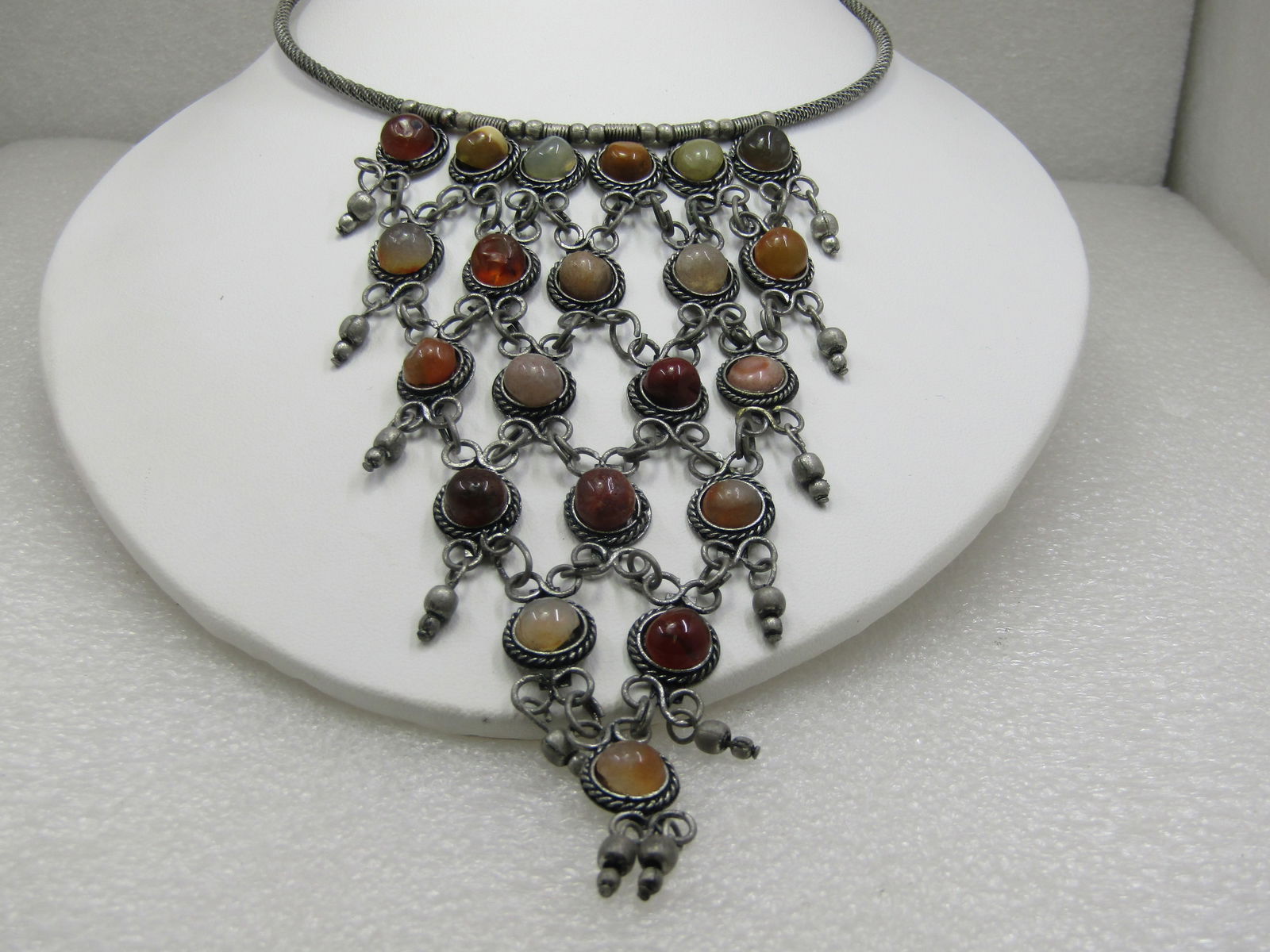 Vintage Coiled Collar Bib Necklace, 17", Stone 5" Drop: Vintage Coiled Collar Bib Necklace, 17", Stone 5" Drop with a mix of earthtone colored stones set in a rope accent frame with six stones at top tapered to a point with one stone at the bottom, silver