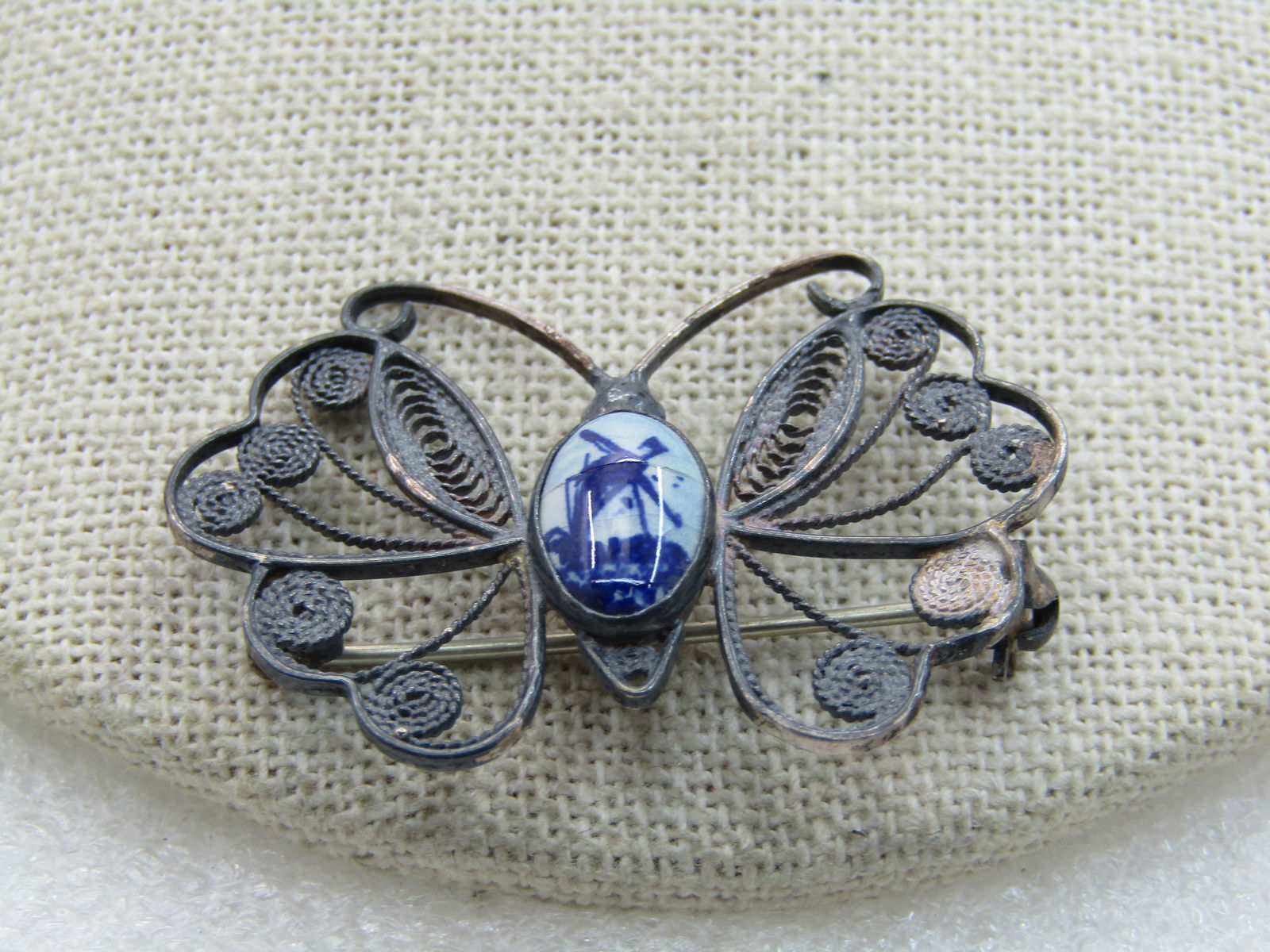 Vintage .835 Silver Delft Butterfly Brooch, Filigree, Mid-Century: Vintage .835 Silver Delft Butterfly Brooch, Filigree, Mid-Centurym 1-5/8" wide and 1.25" Tall. Weight is apx. 4.25 gr. Age is appx. 1950's. It has a center blue delft windmill bezel-set painted stone