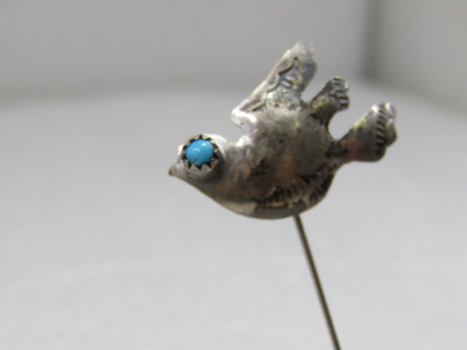Vintage Sterling Southwestern Dove, Turquoise Eye Stick Pin, 1960's-1970's: Vintage Sterling Southwestern Dove, Turquoise Eye Stick Pin, 1960's-1970's with safety cap. The dove has a snake eye turquoise eye. The dove is appx. 1" wide and 3/4" tall with stamped markings on