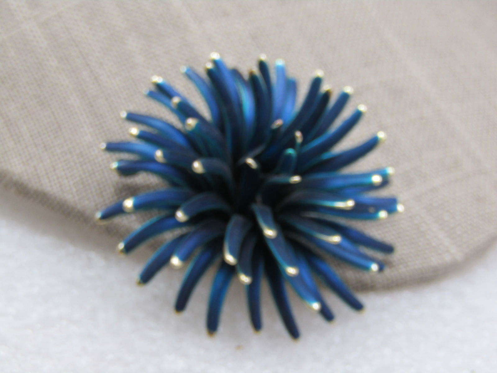 Vintage Teal Enameled Spider Mum Blossom, 2", 1960's: Vintage Teal Enameled Spider Mum Blossom, 2", 1960's. Gold tone tips. This is a tall brooch that is appx. 1" creating a 3-D Blossom. Not signed by the maker. Some enamel wear on the pinback bracket, o