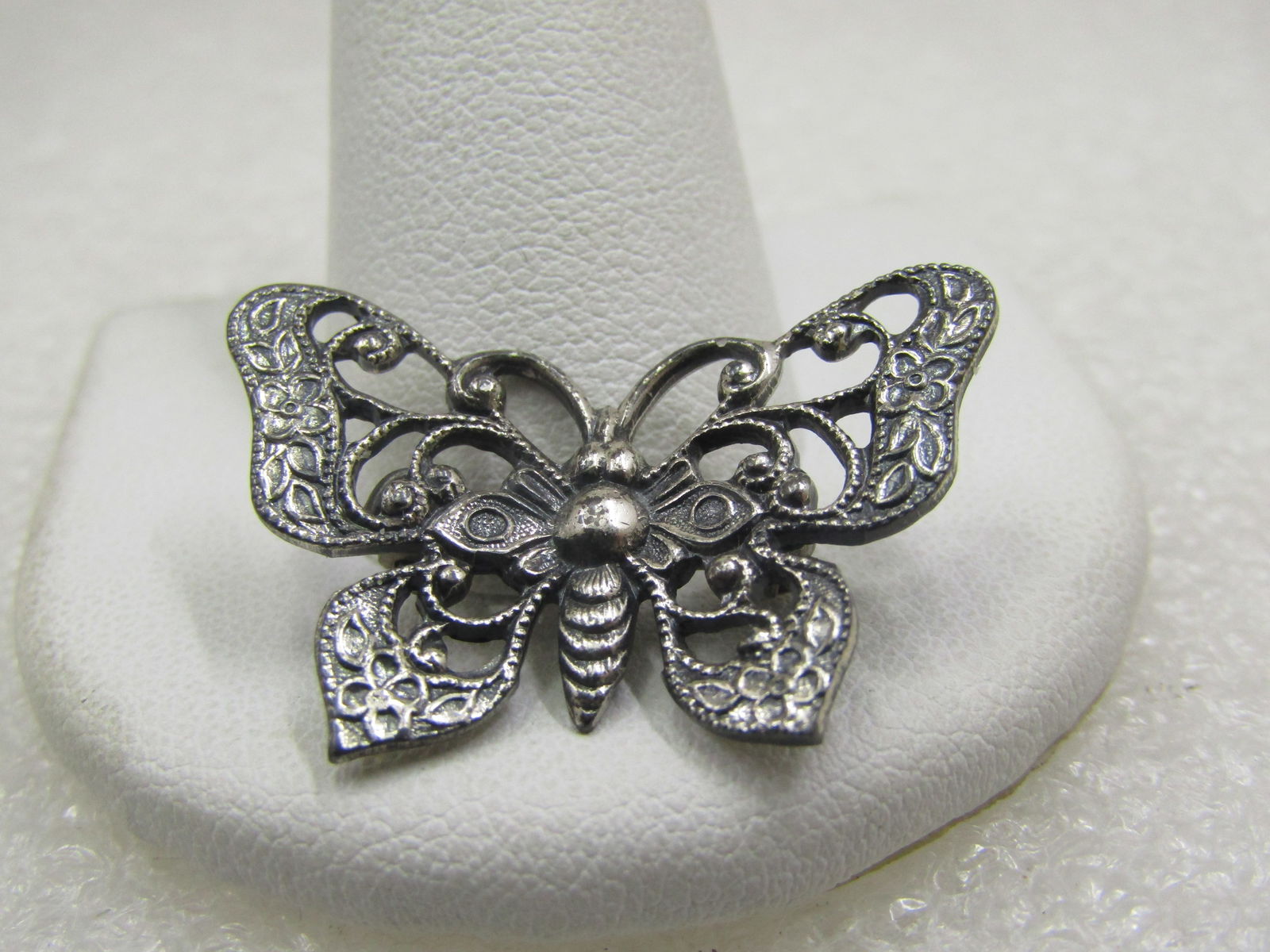 Vintage Sterling Butterfly Brooch, Scrolled, 1-1/8": Vintage Sterling Butterfly Brooch, Scrolled, 1-1/8" wide and 3/4" tall. Filigree design with the look when first viewing that it could have marcasites stones, but it does not - simply a mix of smoth a