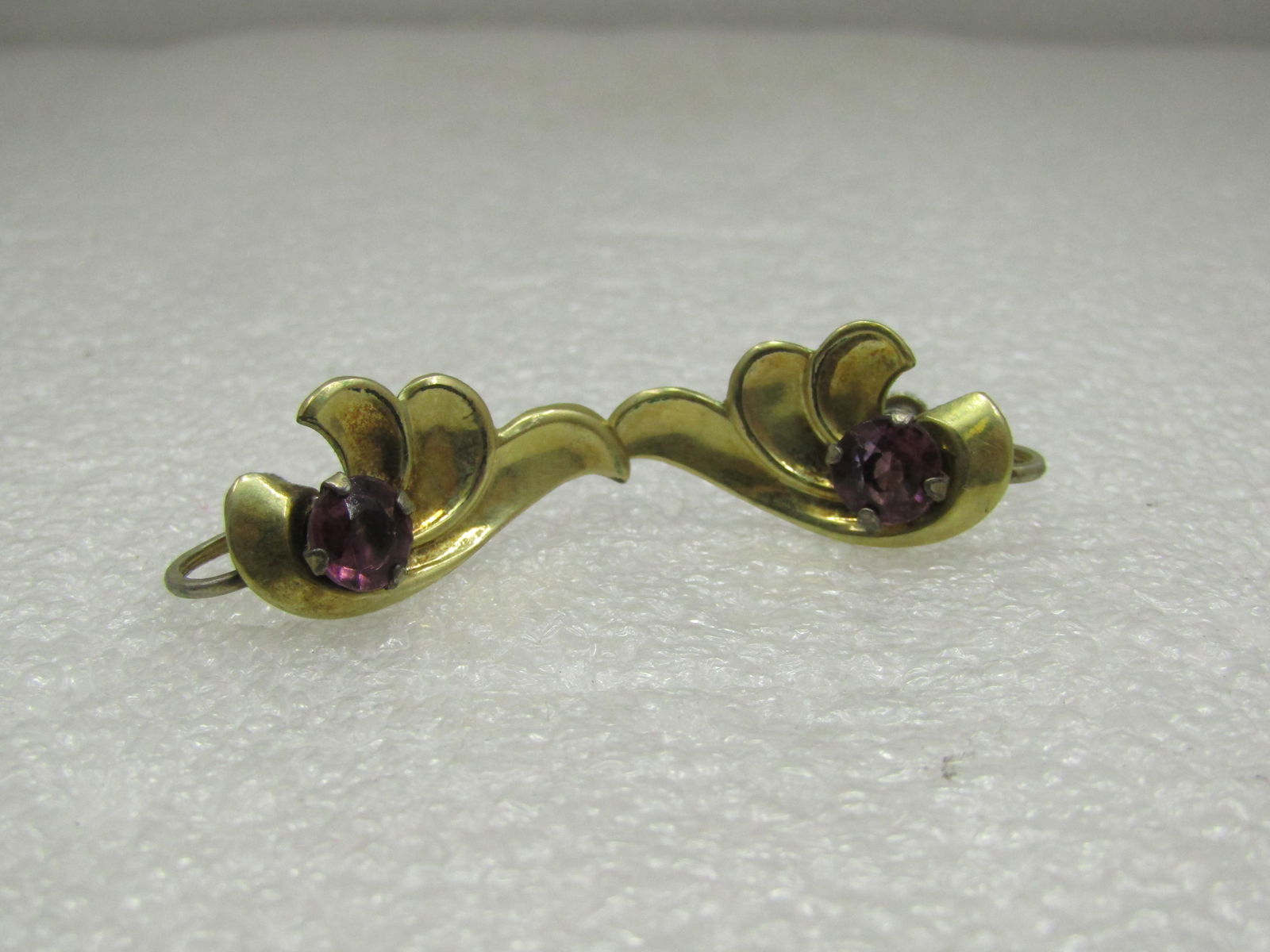 Sterling Gold Vermeil Purple Rhinestone Leaf Earrings, 1940's: Sterling Gold Vermeil Purple Rhinestone Leaf Earrings, 1940's. Wing-like design that is1" wide and 5/8" tall with a purple 6mm round rhinestone prong-set on the earring. They are marked sterling and t