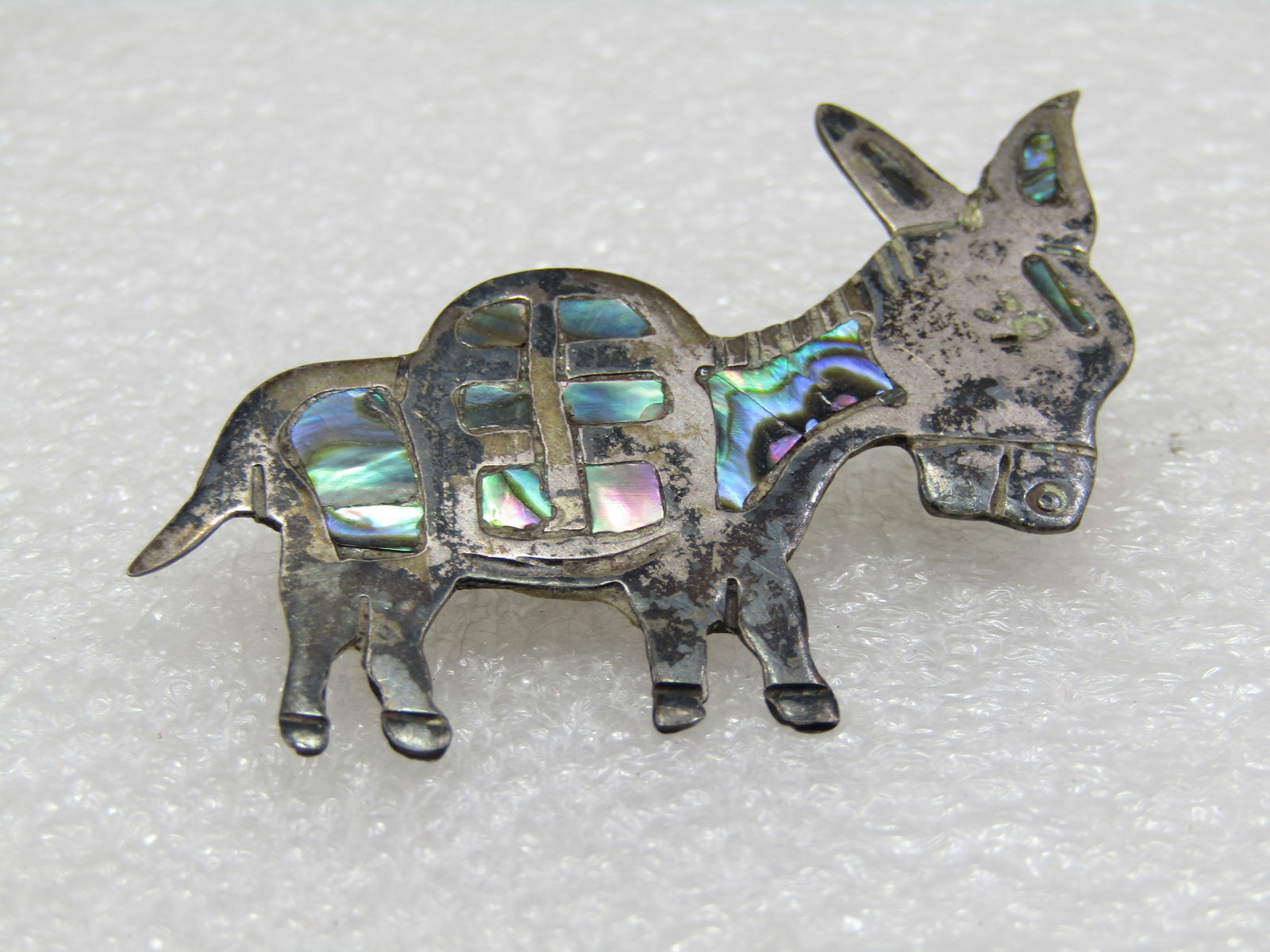 Vintage Sterling Inlaid Abalone Donkey Brooch, Mexico, Signed: Vintage Sterling Inlaid Abalone Donkey Brooch, Mexico, Signed what looks like ERB and also marked Hecho en Mexico and .925. Tested. Weight is appx. 6.36 gr. Appx. 2" long and 1.5 from ears to hooves.