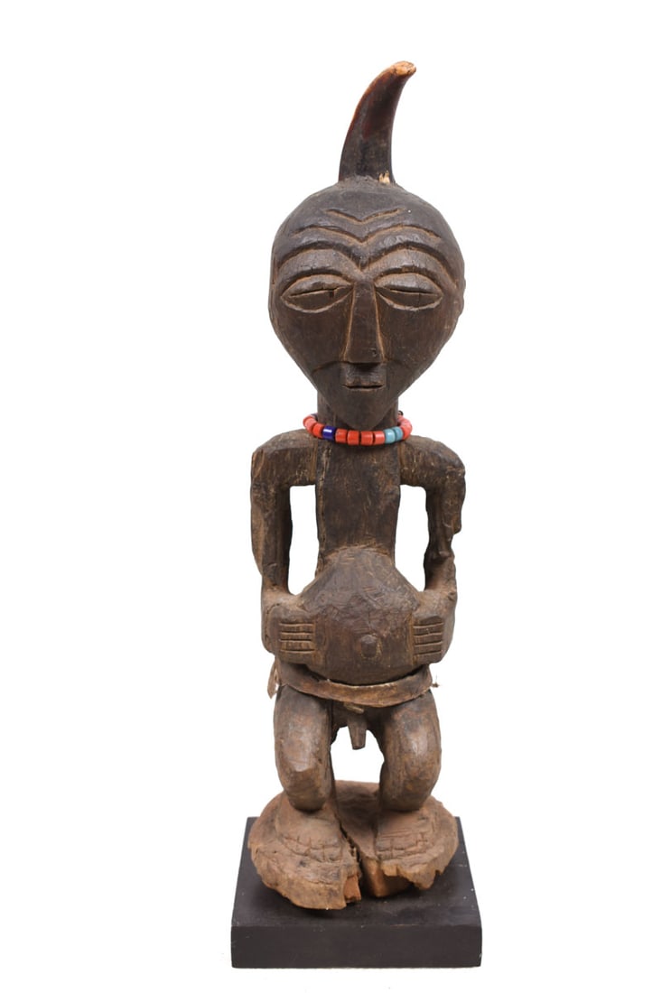 Power Figure – Wood, Horn – Songye – Congo: Great Songye power figure from DR Congo. Stylistic wooden ancestor figure of the SONGYE tribe from D.R. Congo. Great eye for detail. It served to protect the family against diseases, accidents, bad sp