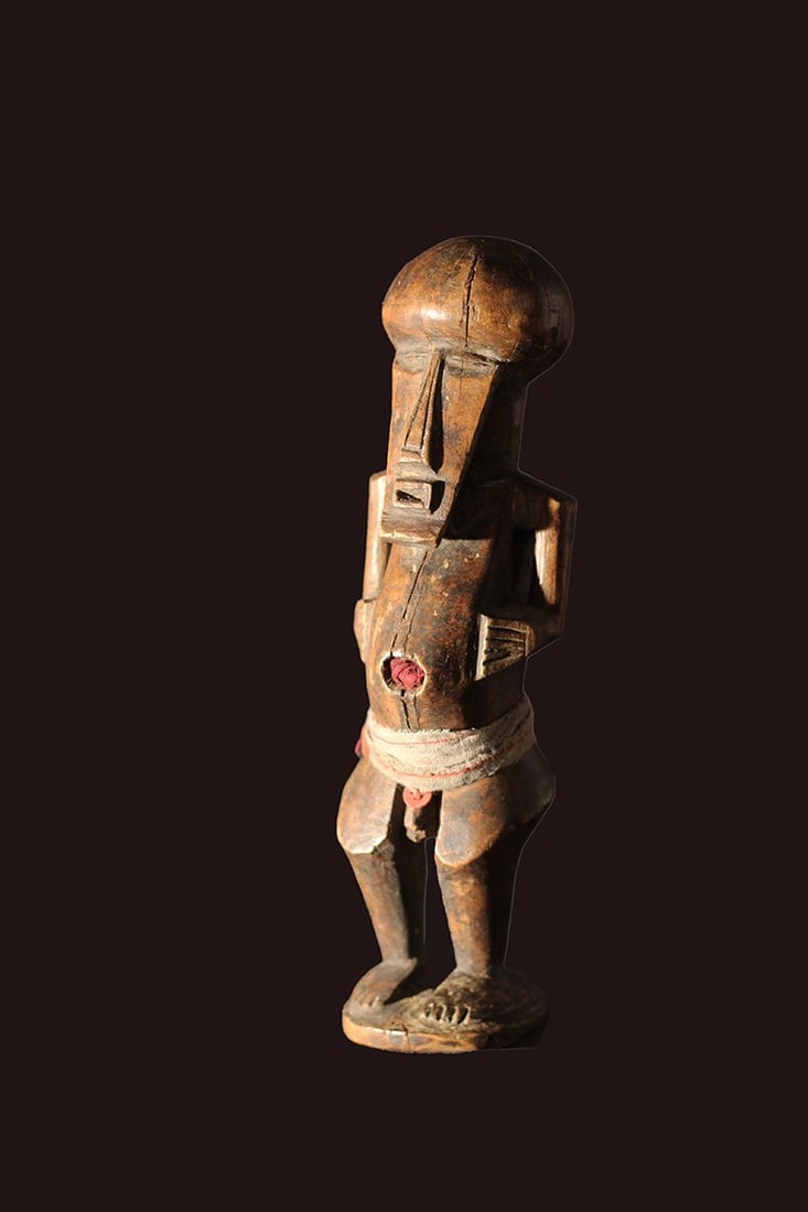 Power Figure – Wood – Songye – Congo: Beautiful Songye power figure from DR Congo. Stylistic wooden ancestor figure of the SONGYE tribe from D.R. Congo. It served to protect the family against diseases, accidents, bad spirits and bewitchm