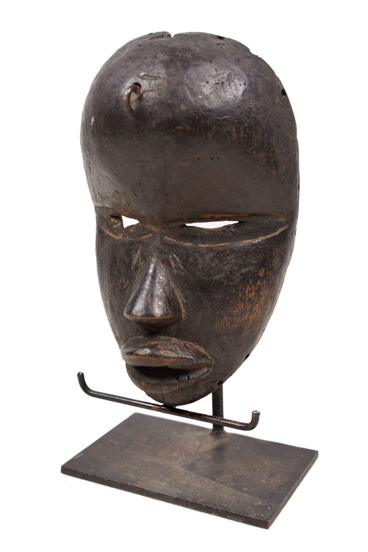 Mask – Wood – Dan – Ivory Coast: Authentic Dan mask in a very expressive design. The Dan style is quite evident, with slith eyes and large bulging mouth Good condition with a beautiful aged patina on the wood. The border between