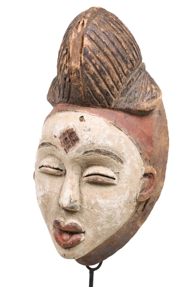 Initiation mask – Wood – Punu – Gabon: Wooden initiation mask from the PUNU tribe, Gabon. PUNU masks are thought to represent ancestors` faces. They are worn during funerals and by a Moukouji initiate who stands on stilts. This masks has