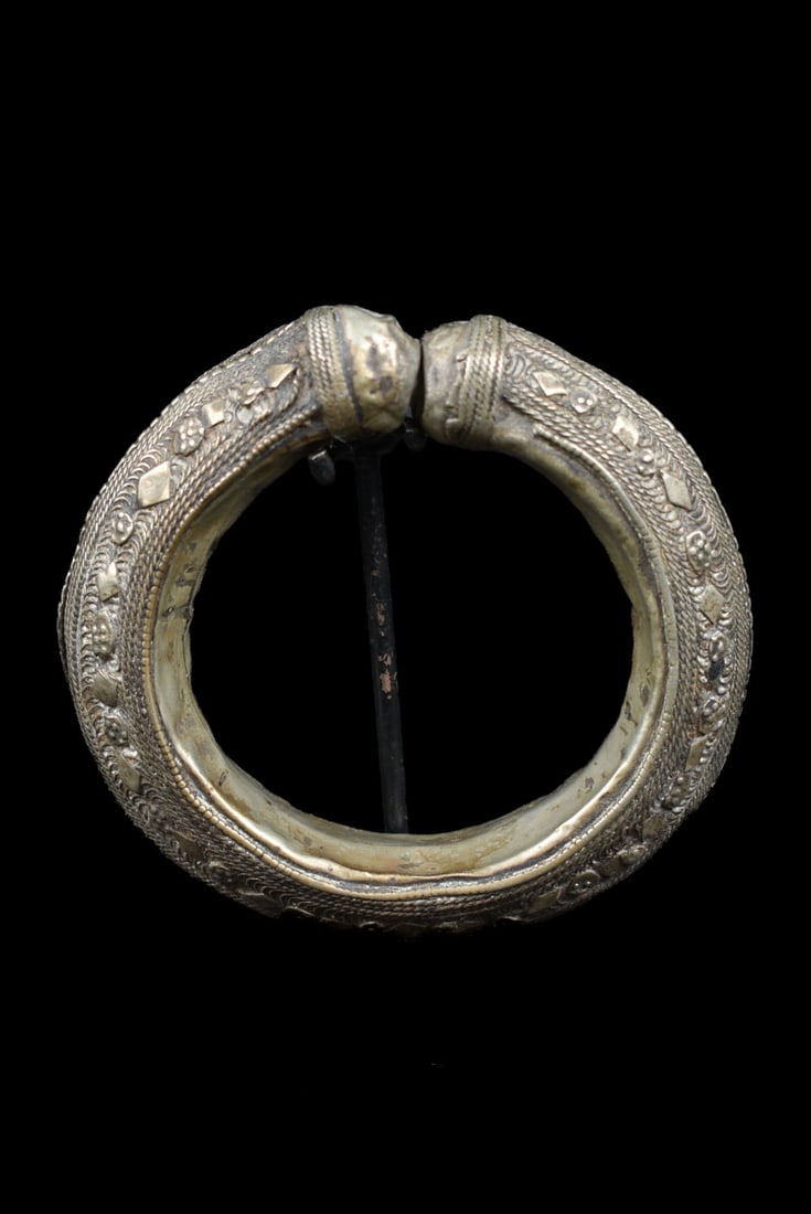 Bracelet – Metal – Yemen: An unique Rashaida bracelet from Yemen, crafted in metal, silver colored with intricate geometric and beaded designs. This bold tribal bangle was traditionally worn as both ornament and wealth, with