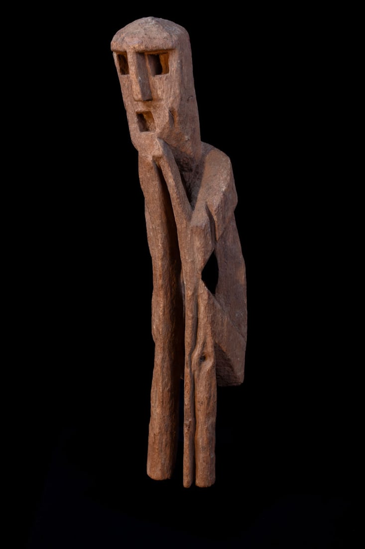 Ancestor Figure – Wood – Nepal: Great standing wooden ancestor figure from Nepal. Wood, covered with red pigment, standing with in the namaste gesture of greeting and protection. Ancestor figures were placed on family shrines.