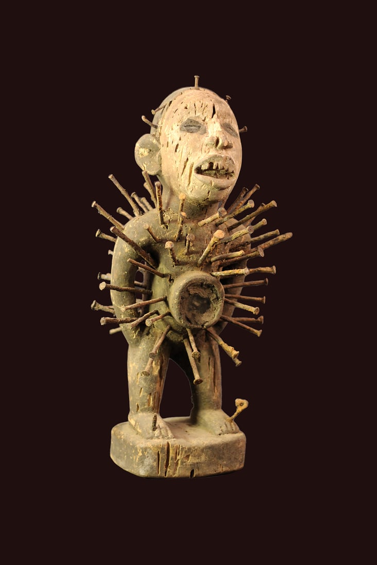 Nkisi Figure – Wood, Nails – Yombe – Congo: Very complete Nkisi fetish figure from the Yombe tribe of DR Congo. A Nkisi refers to the spiritual nature of the figure where nkondi refers to the power of the figure itself. Spiritual and religious