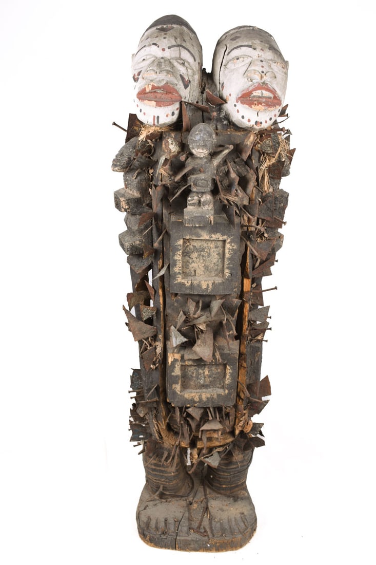Double headed Nkisi Figure – Wood, Nails, Iron – Kongo- Congo: Enormous Nail fetish figure from the Bakongo tribe of DR Congo. Large and heavy figure, total height 120 cm (14 kg). Coming from the Kongo peoples, a Nkisi refers to the spiritual nature of the