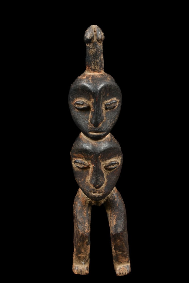 Fertility Figure – Wood – Lega – DR Congo: Fertility figure from the Lega tribe of DR Congo. The figure with two faces has a phallus on top, a symbole of fertility. These kind of figures were used during initiation ceremonies. Good condition w