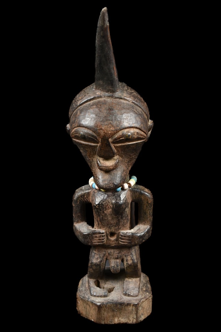 Power Figure – Wood, Horn, Beads – Songye – Congo: Great Janus Songye power figure from DR Congo. Stylistic wooden ancestor figure with 2 faces of the SONGYE tribe from D.R. Congo. It served to protect the family against diseases, accidents, bad spiri
