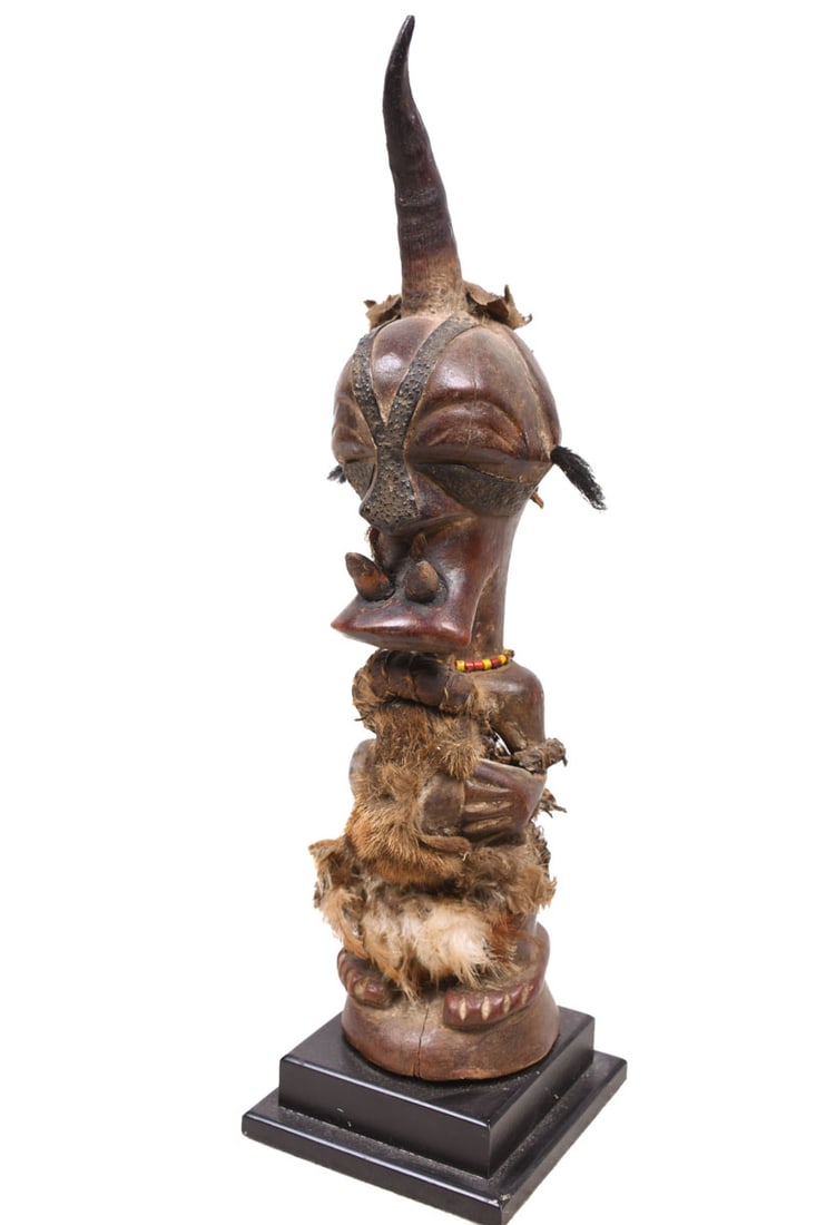 Power Figure – Wood, Horn, Beads – Songye – Congo: Authentic Songye power figure from DR Congo. Stylistic wooden ancestor figure of the SONGYE tribe from D.R. Congo. It served to protect the family against diseases, accidents, bad spirits and bewitchm
