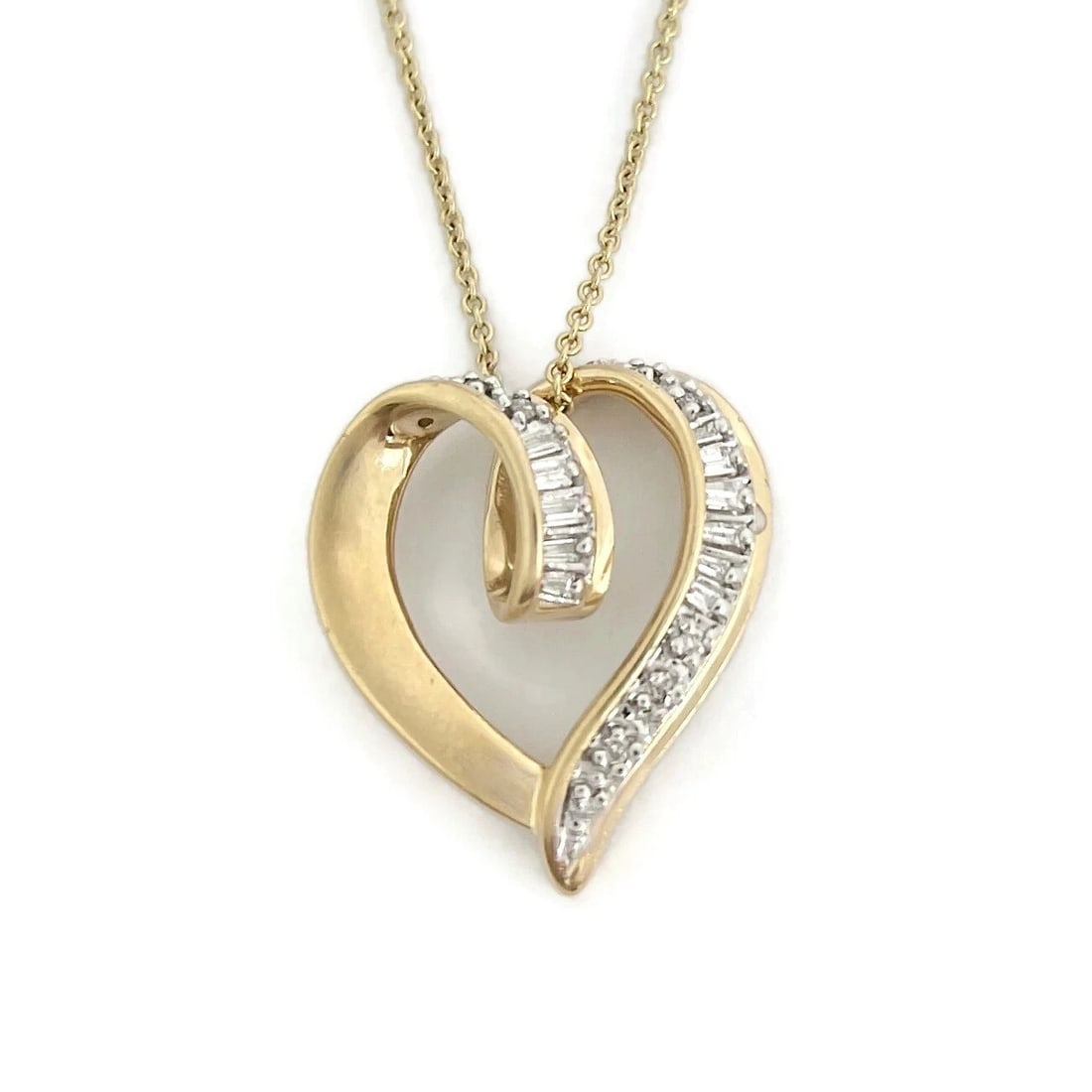 Vintage Baguette Half Diamond Heart Pendant Necklace 14K Yellow Gold, 6.20 Grams: Vintage Baguette Half Diamond Heart Pendant Necklace 14K Yellow Gold, 6.20 Grams This is a beautiful necklace. Please let us know if you have any questions :) Circa: 1980's Diamonds: 10 round brillian