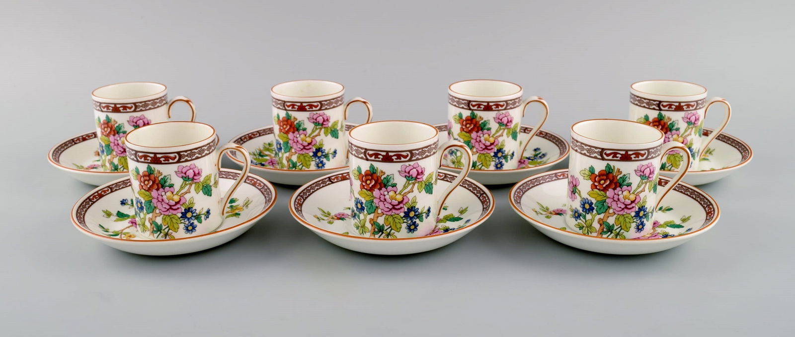 Coalport, England. Seven Flower of Tibet chocolate cups with saucers decorated with flowers and gold (1 of 7)