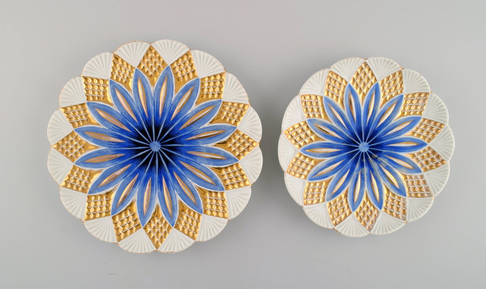 Two antique Meissen plates in hand-painted porcelain. Blue flowers and gold decoration. Early 20th: Title: Two antique Meissen plates in hand-painted porcelain. Blue flowers and gold decoration. Early 20th century. Description: Two antique Meissen plates in hand-painted porcelain. Blue flowers and g