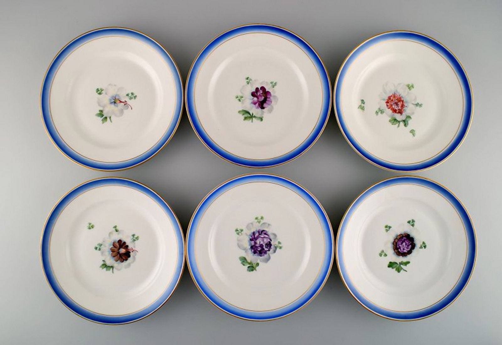 Six antique Royal Copenhagen plates in hand-painted porcelain with flowers and blue border with (1 of 6)