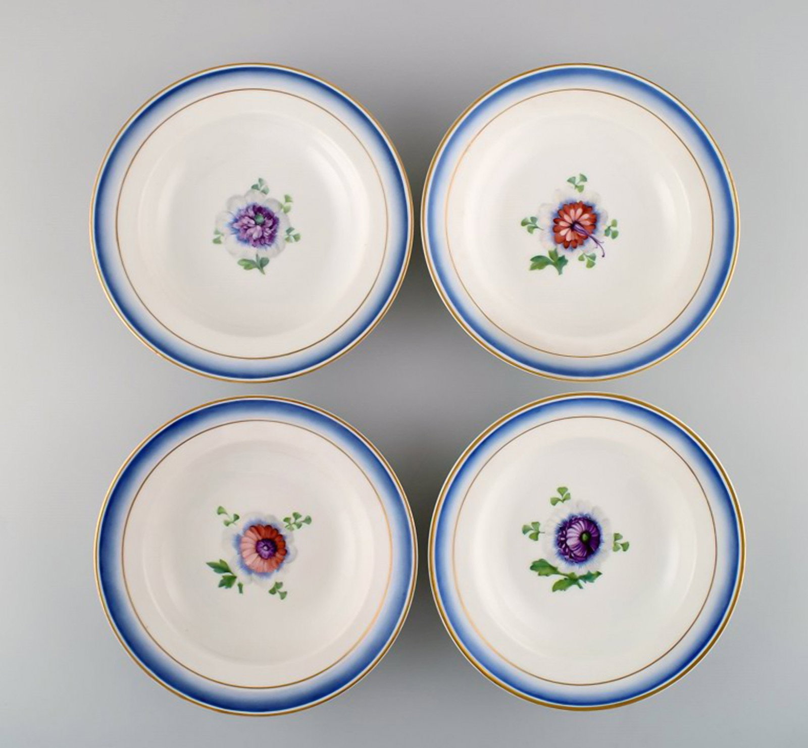 Four antique Royal Copenhagen deep plates in hand-painted porcelain with flowers and blue edge with (1 of 6)