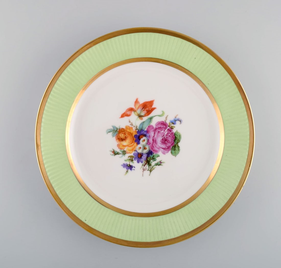 Royal Copenhagen plate in hand-painted porcelain with floral motif and edge in light green and gold. (1 of 5)