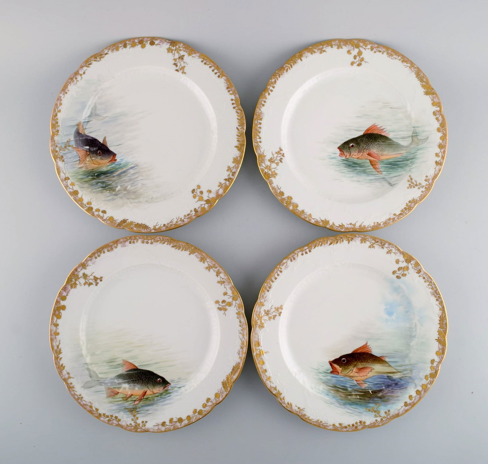 Twelve antique Pirkenhammer porcelain dinner plates with hand-painted fish and gold decoration. High - 4