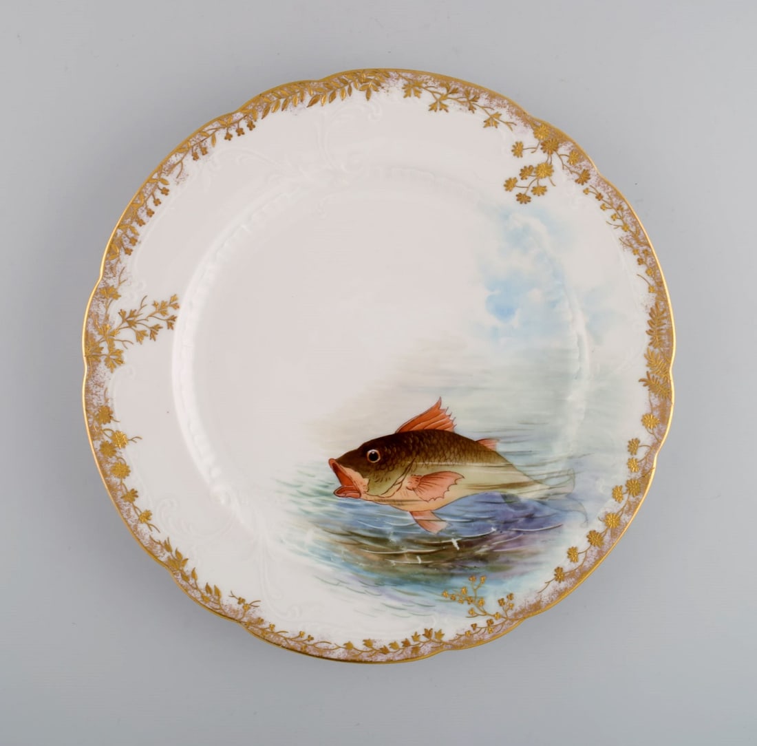 Twelve antique Pirkenhammer porcelain dinner plates with hand-painted fish and gold decoration. High - 5