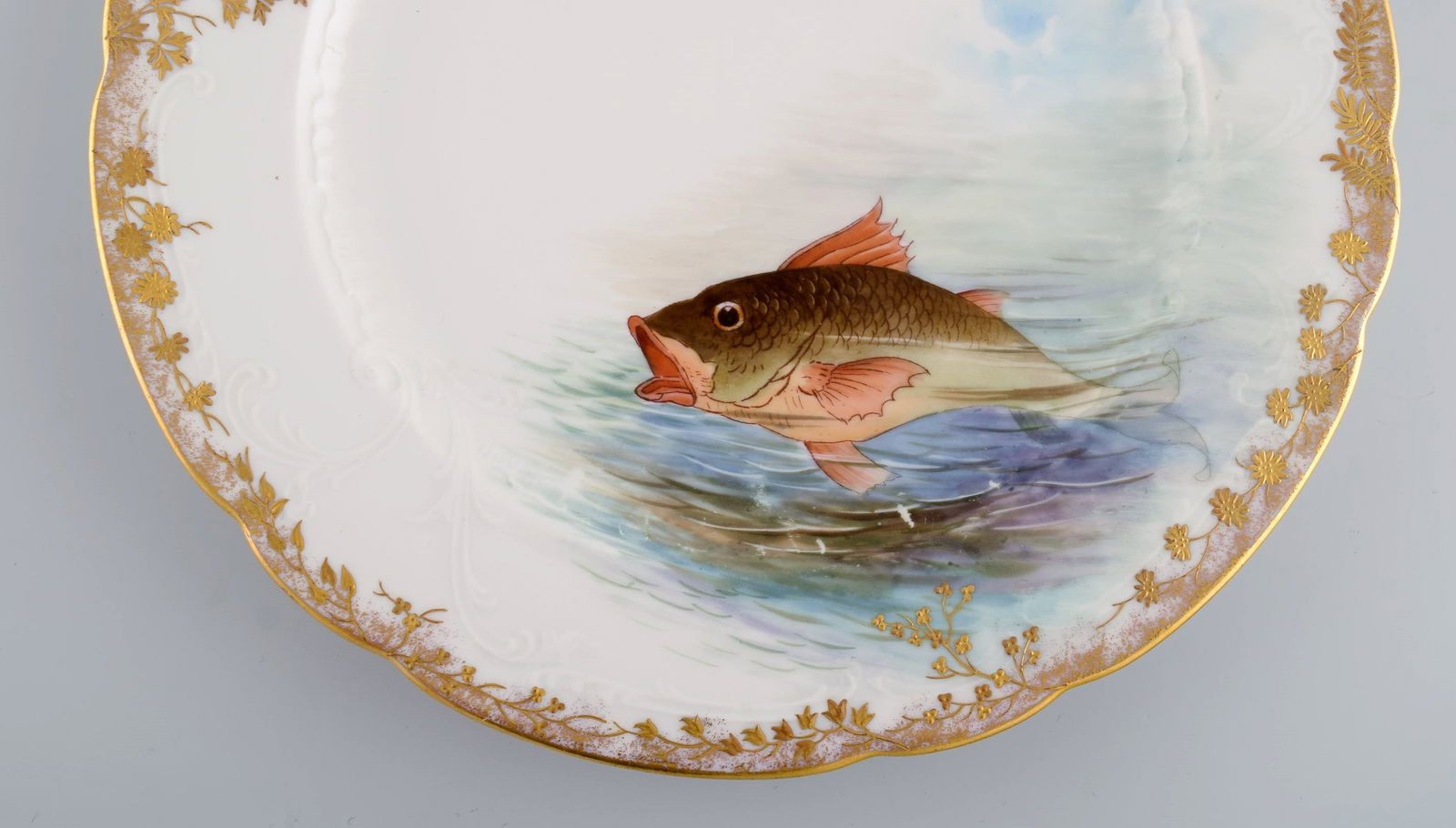 Twelve antique Pirkenhammer porcelain dinner plates with hand-painted fish and gold decoration. High - 6