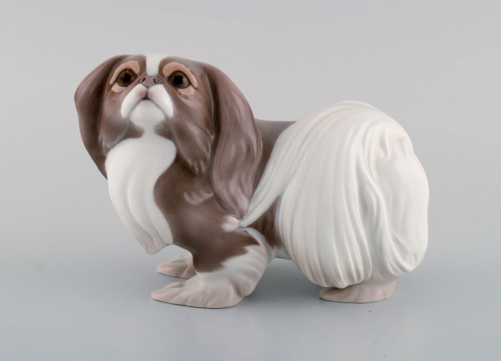 Sveistrup Madsen for Bing & Grøndahl. Porcelain figure. Standing Pekingese. Mid-20th century. (1 of 7)