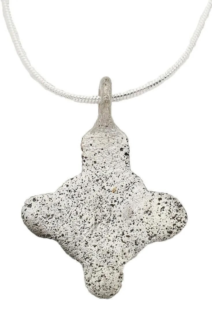 EUROPEAN WOMAN'S PENDANT, C.1250-1450 AD: Silvered bronze, over 7/8" width. Of quatrefoil form. This form is thought to represent the targets at which knights rode in field events like the Landshuter Hochzeit. A series of targets were hung