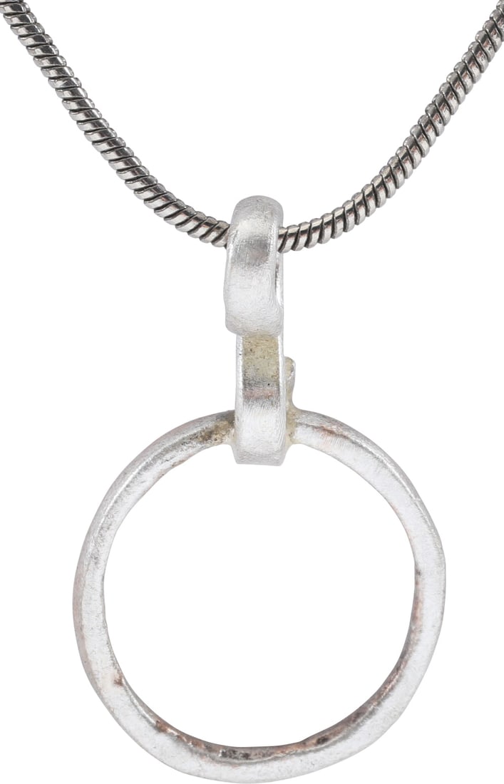 VIKING BEARD RING NECKLACE, 9TH-11TH CENTURY: Round with rounded face and flat edges, 0.51” inside diameter and 0.59” outside. The use of beard rings by Vikings is well documented though very few genuine examples survive. Surface text