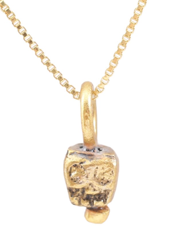 MEDIEVAL TIBETAN SKULL PRAYER BEAD NECKLACE: This small bronze bead, hand crafted about 1400-1550 was part of a Buddhist prayer ritual. It was strung along with others, each showing differences from hand work, to aid the devotee by focusing