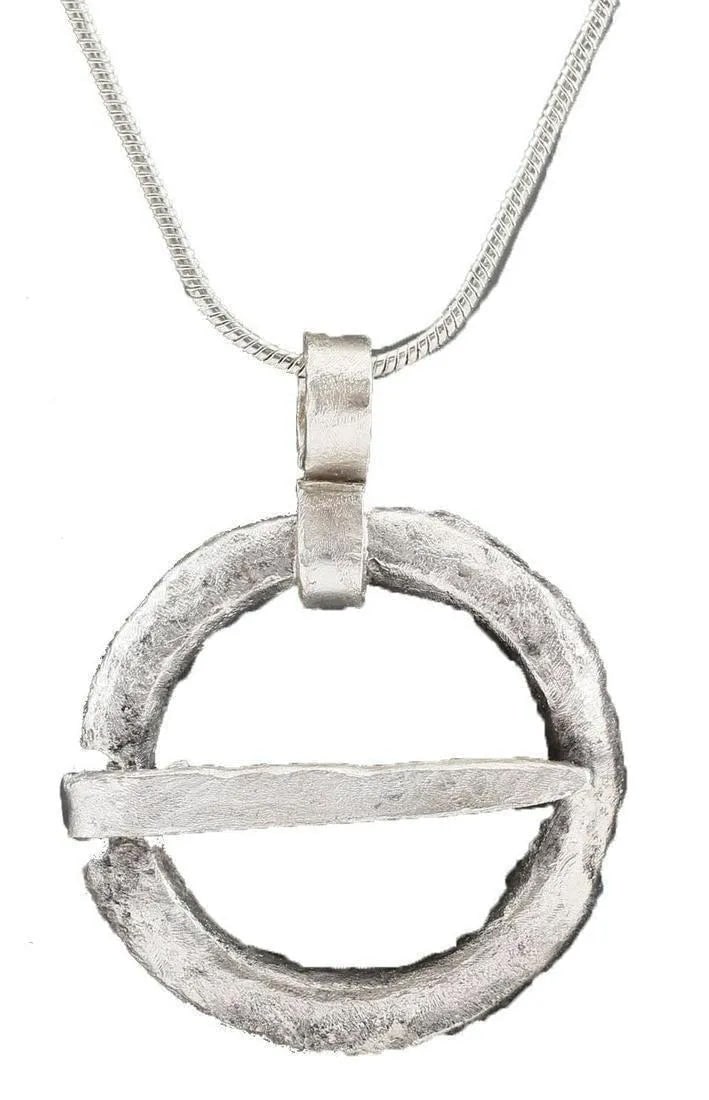 VIKING PROTECTIVE ARMOR BROOCH NECKLACE, 10th-11th CENTURY: 10th Century. Bronze, just over 1" diameter. Circular, with broad rounded face, flat back, and ridged edge. The surface is textured from burial. Professionally conserved and the pure silver surface