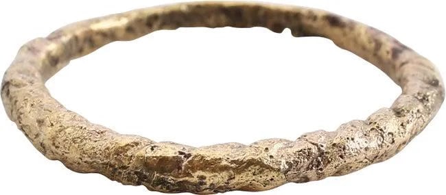 VIKING ROPED OR TWIST WEDDING RING, C.866-1067 AD, SIZE 10: C.866-1067 AD. Cambridgeshire, England. Large size 10 with bold twist motif 2/3 its circumference. The spiral or helix was a favorite Viking form. Professionally refurbished with the 24karat gold over