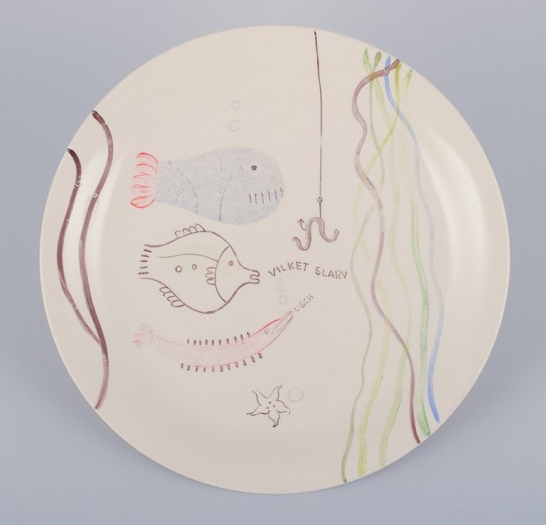 Stig Lindberg for Gustavsberg. "Löja" plate. Hand-painted with a fish motif. Satirical: Title: Stig Lindberg for Gustavsberg. "Löja" plate. Hand-painted with a fish motif. Satirical illustration with Swedish text. Description: Stig Lindberg for Gustavsberg. "Löja" plate. Hand-p