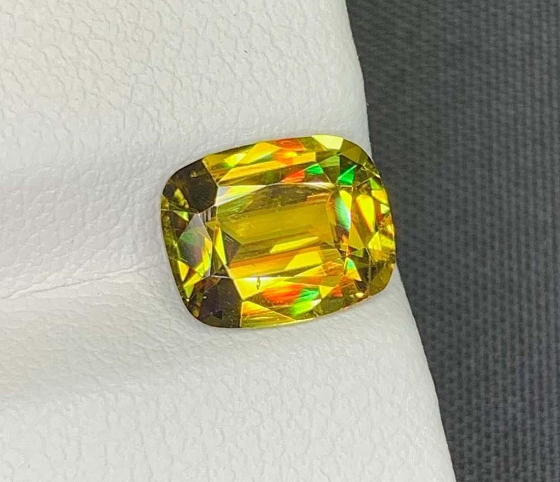 AIG Certified Lustrous Sphene Gemstone: Yellow/Green Cushion Cut, 2.76 Carat: Title: AIG Certified Lustrous Sphene Gemstone: Yellow/Green Cushion Cut, 2.76 Carat Description: Materials: Gemstone: Sphene Natural Sphene Titanite Gemstone, Full Fire Lustrous Yellow/Green Sphene We
