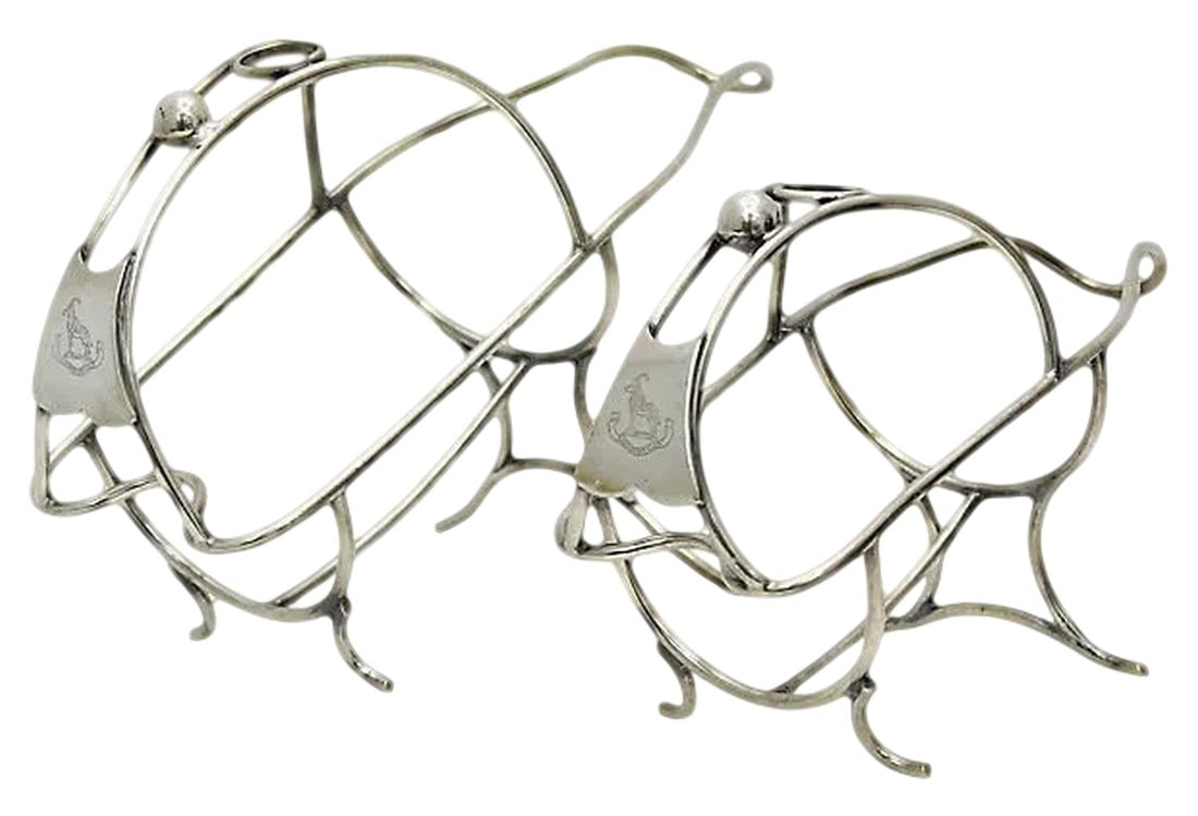 Antique Mappin & Webb Wine Caddies, a Pair: An opulent pair of antique wine caddies from Mappin & Webb"”silversmiths to the Crown and the quiet power behind many a well-dressed dining table. Elegantly designed with intertwined scrollwork