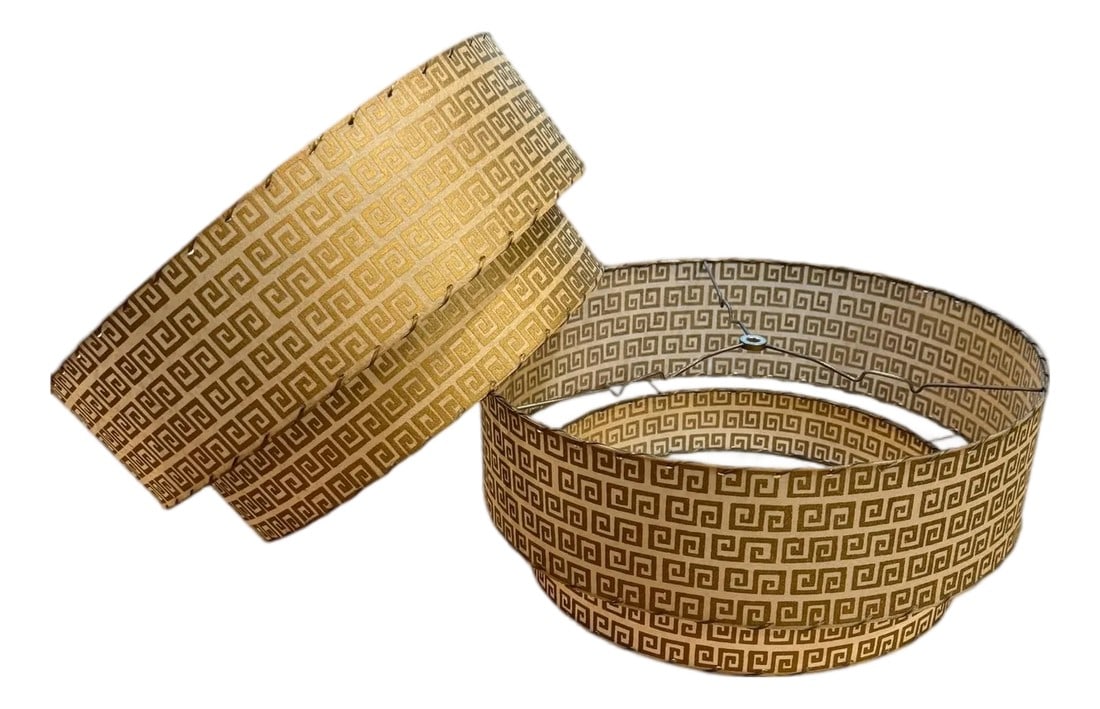 Two-Tier Fiberglass Lampshade With Greek Key Pattern -a Pair: Offering a pair of two-tier fiberglass lampshades in a Greek Key pattern, circa 1950 Gilt Greek key against a beige background. Gilding is in excellent condition as is the fiberglass and gold vinyl