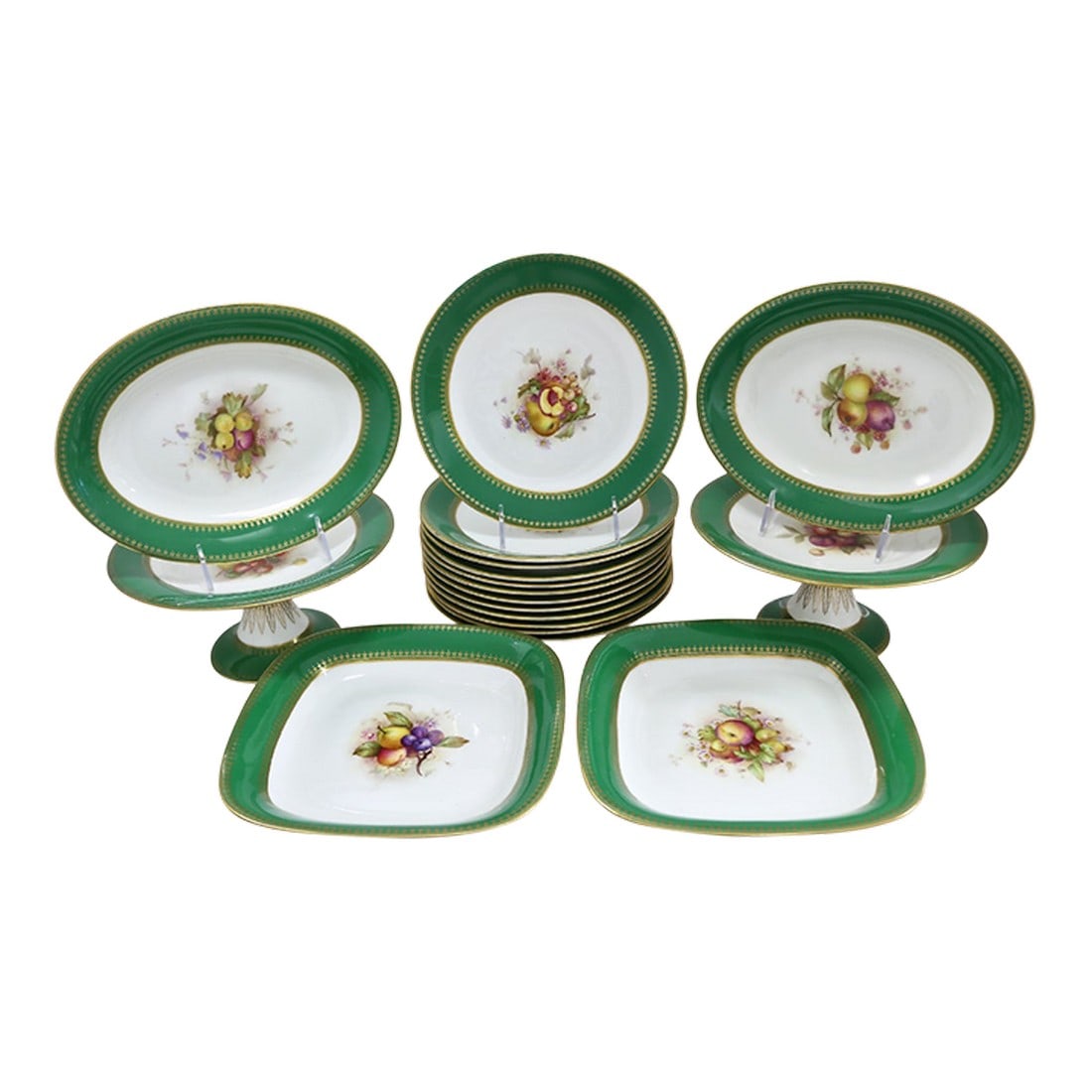 Early 1900s Royal Worcester Green & Gilt Dessert Service, 18 Pieces: Lush, opulent, and unmistakably English. This magnificent Royal Worcester dessert service, circa 1910–1930, features hand-painted fruit studies framed by a rich emerald green border and
