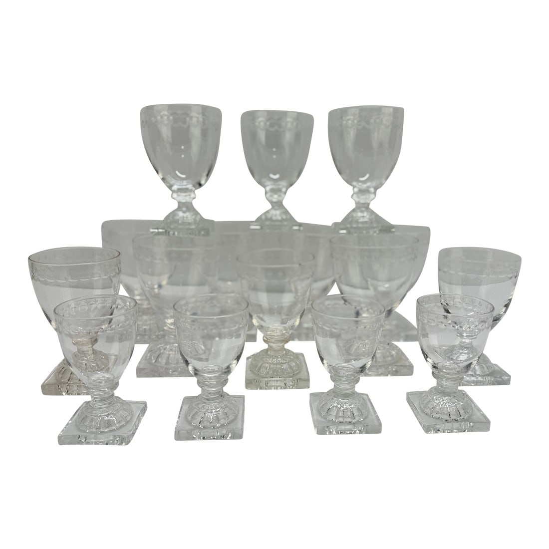 Set of Seventeen Lemon Squeezer–Foot Etched Glasses, C. 1810 & William Yeoward: Please Note: 4 of these glasses are William Yeoward. This is an estate collection with 13 being period 1800-1810 glasses. A substantial and well-balanced service of seventeen English drinking
