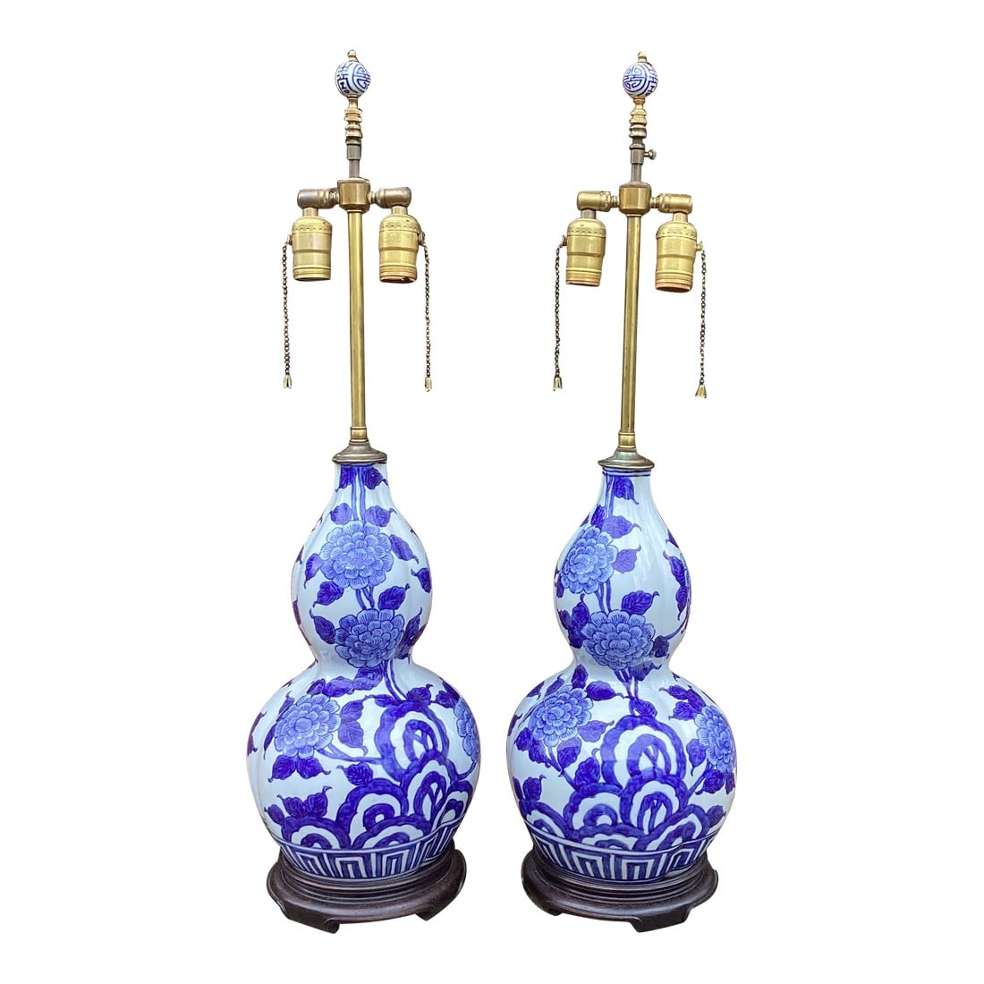 Vintage Pair of Blue and White Gourd Lamps With Dual Pull Chain Sockets: A beautiful pair of vintage double-gourd porcelain lamps featuring hand-painted cobalt blue floral and geometric motifs in the classic Chinese export style. The bodies have excellent scale and