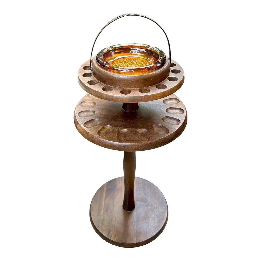 1960s Decatur Industries Free Standing Walnut Pipe Stand With Glass Ashtray: Freestanding walnut 16 hole pipe holder from Decatur Industries with matching amber glass ashtray. Measures 23" tall without handle which folds down when in use. No chips in glass ashtray. Very